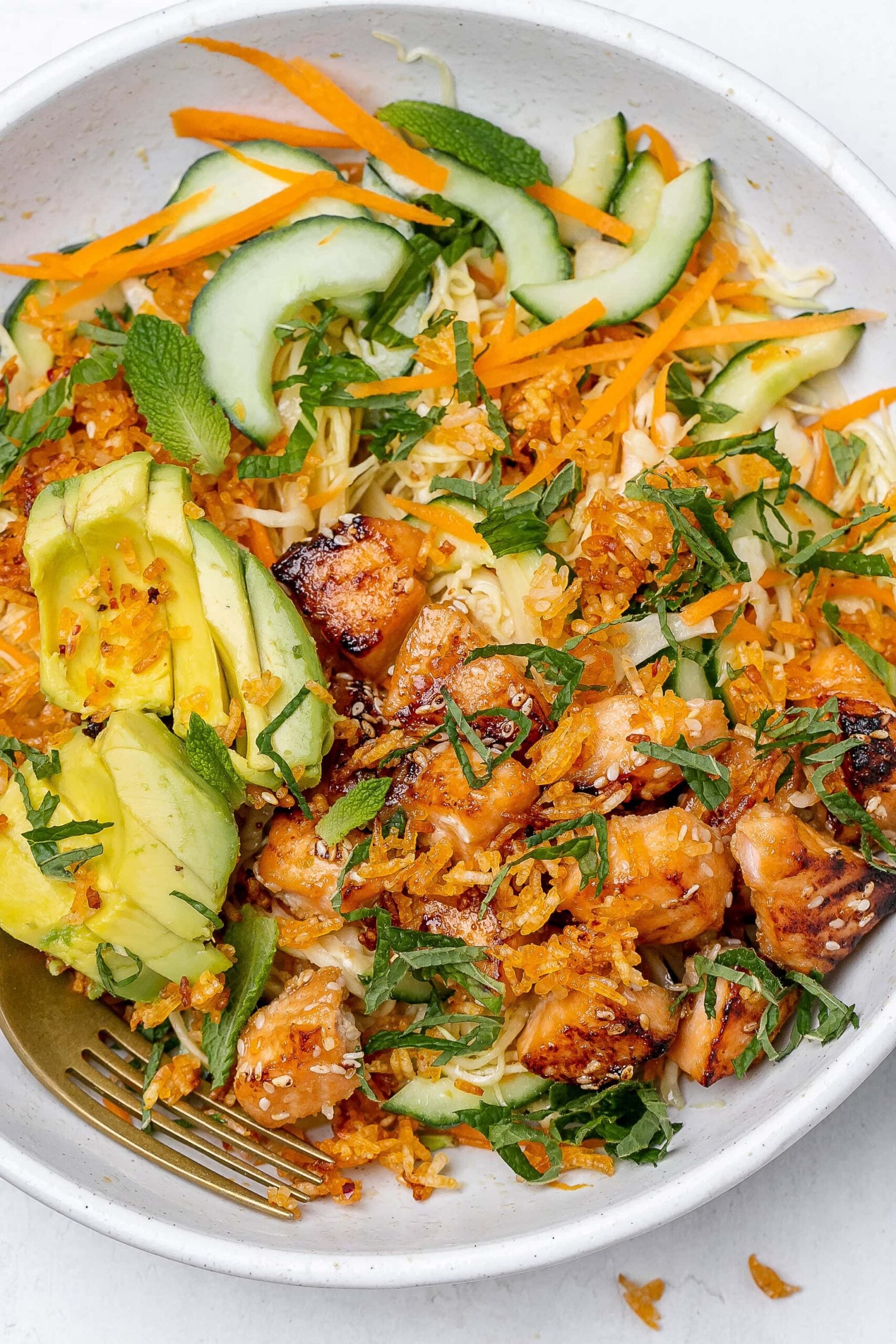 crispy rice salad with salmon in a salad bowl.