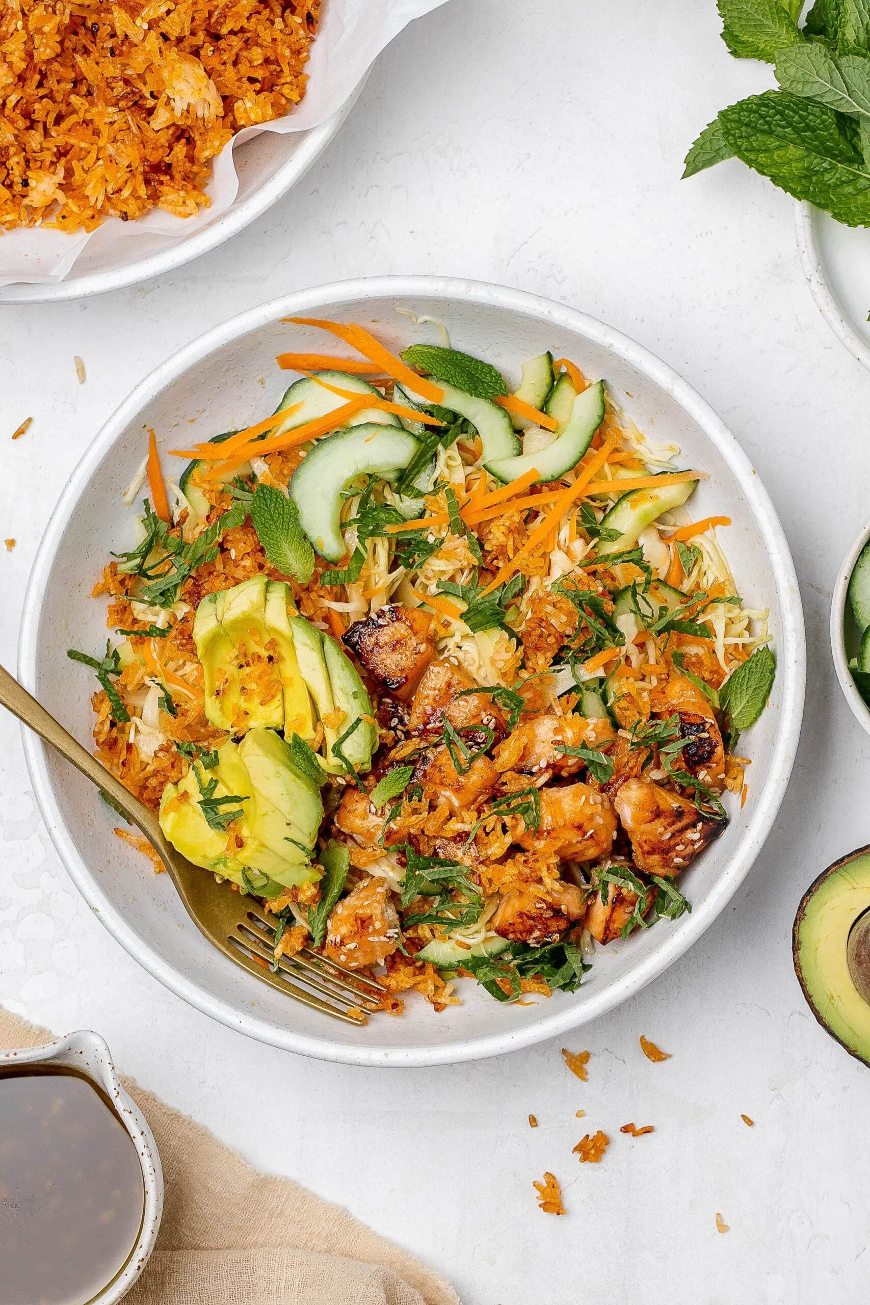 crispy rice salad with salmon in a salad bowl.