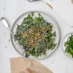 Miso kale caesar salad on a plate with a fork.