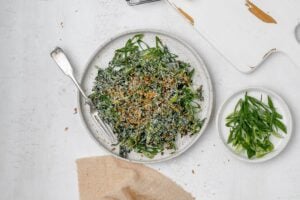 Miso kale caesar salad on a plate with a fork.