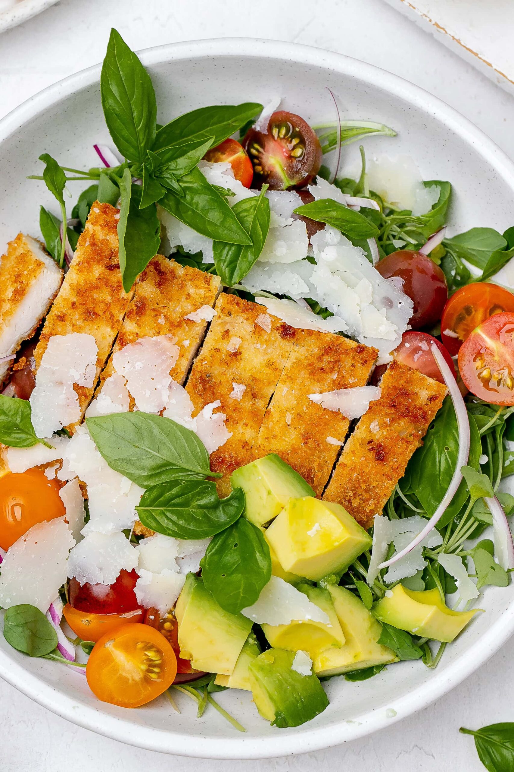 chicken Milanese salad in a bowl.