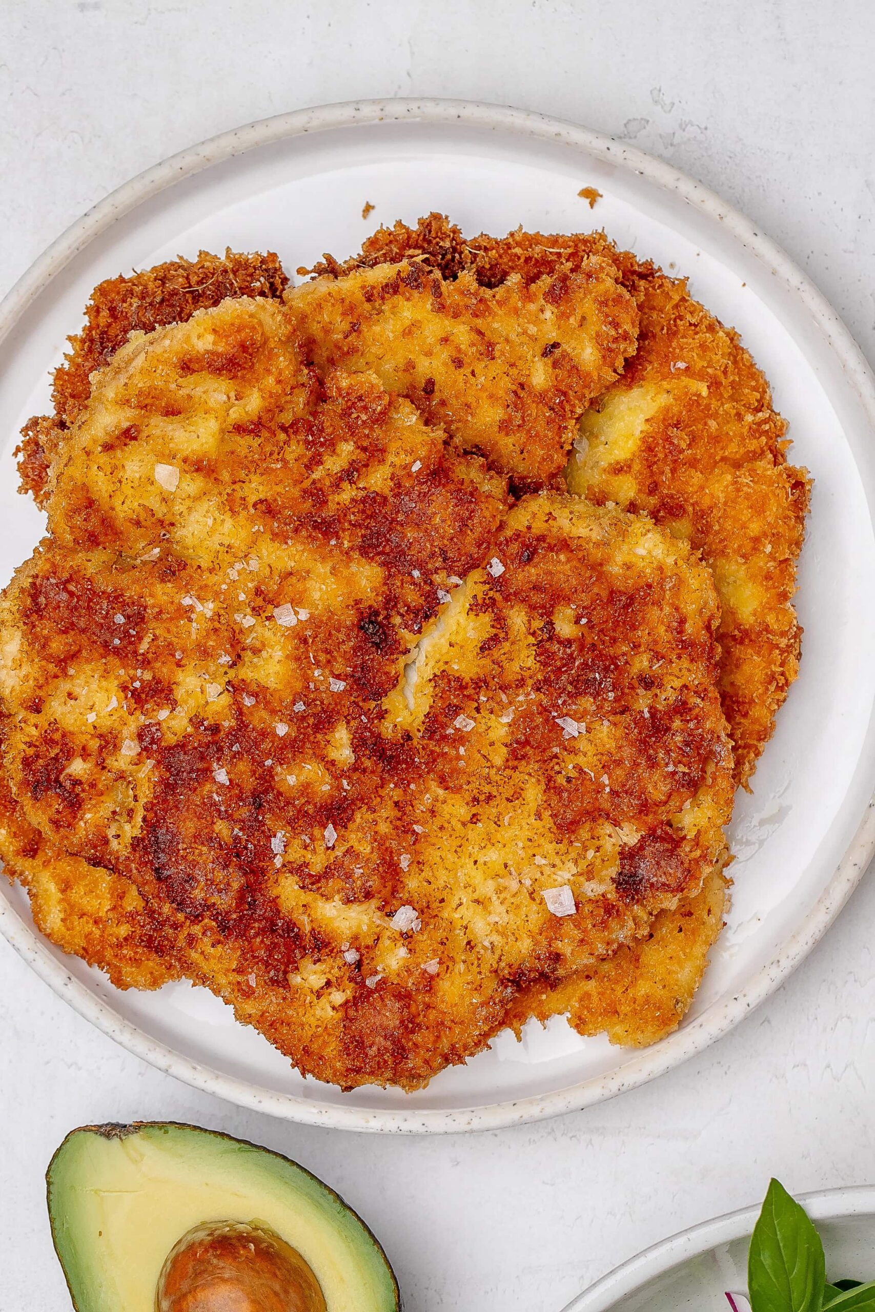 chicken Milanese cutlets on a plate.