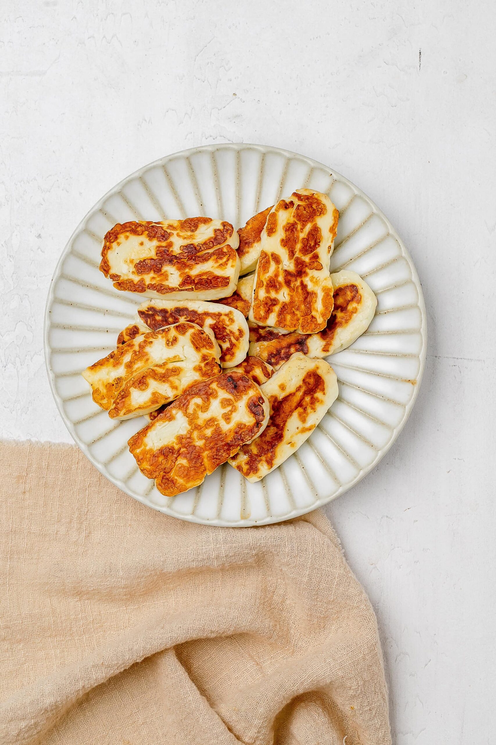 pan fried halloumi slices on a plate.
