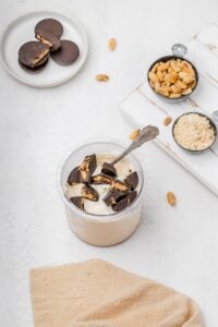 Ninja Creami peanut butter ice cream in pint with chopped peanut butter cups on top.