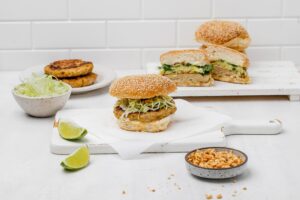 Thai chicken burger on a bun with slaw topping.