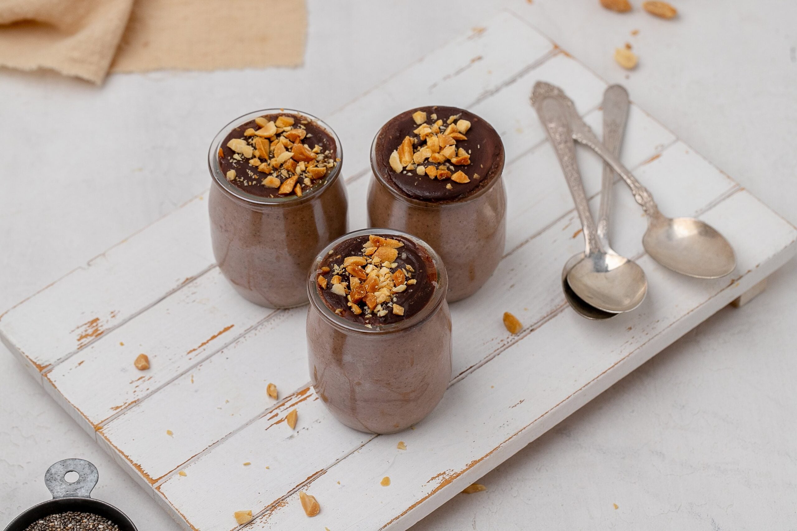 chocolate peanut butter chia seed pudding in glass jars.