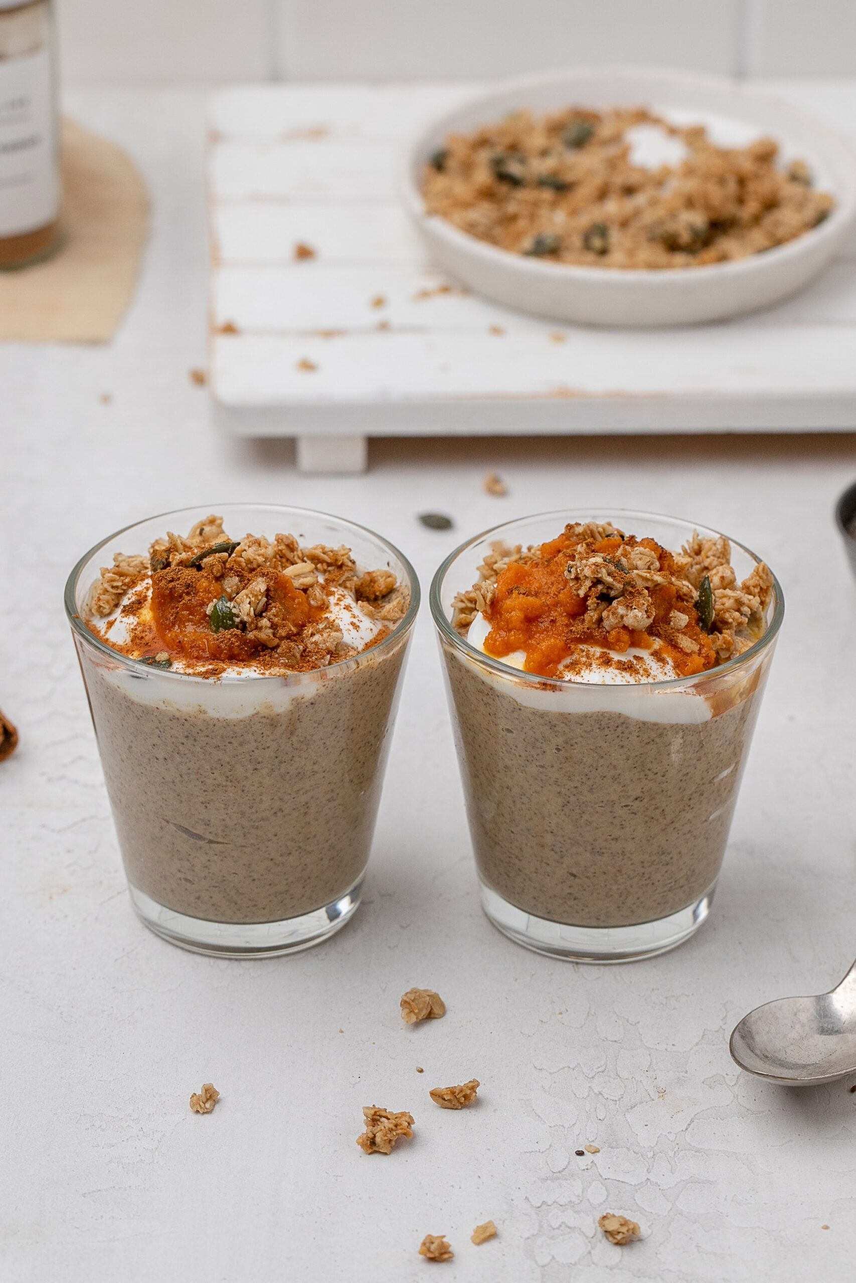 pumpkin chia seed pudding in a glass jar with toppings. 