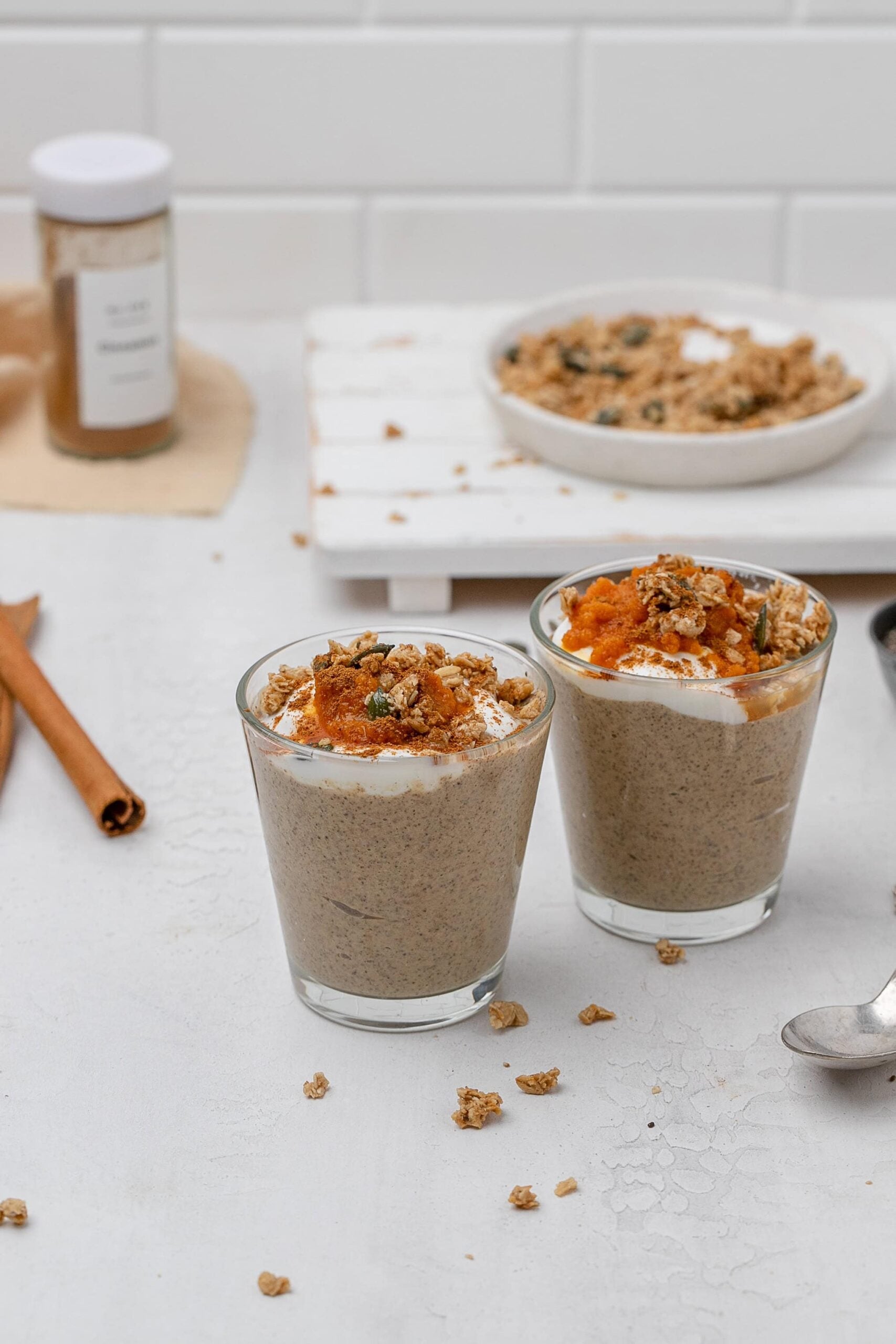 pumpkin chia seed pudding in a glass jar with toppings. 