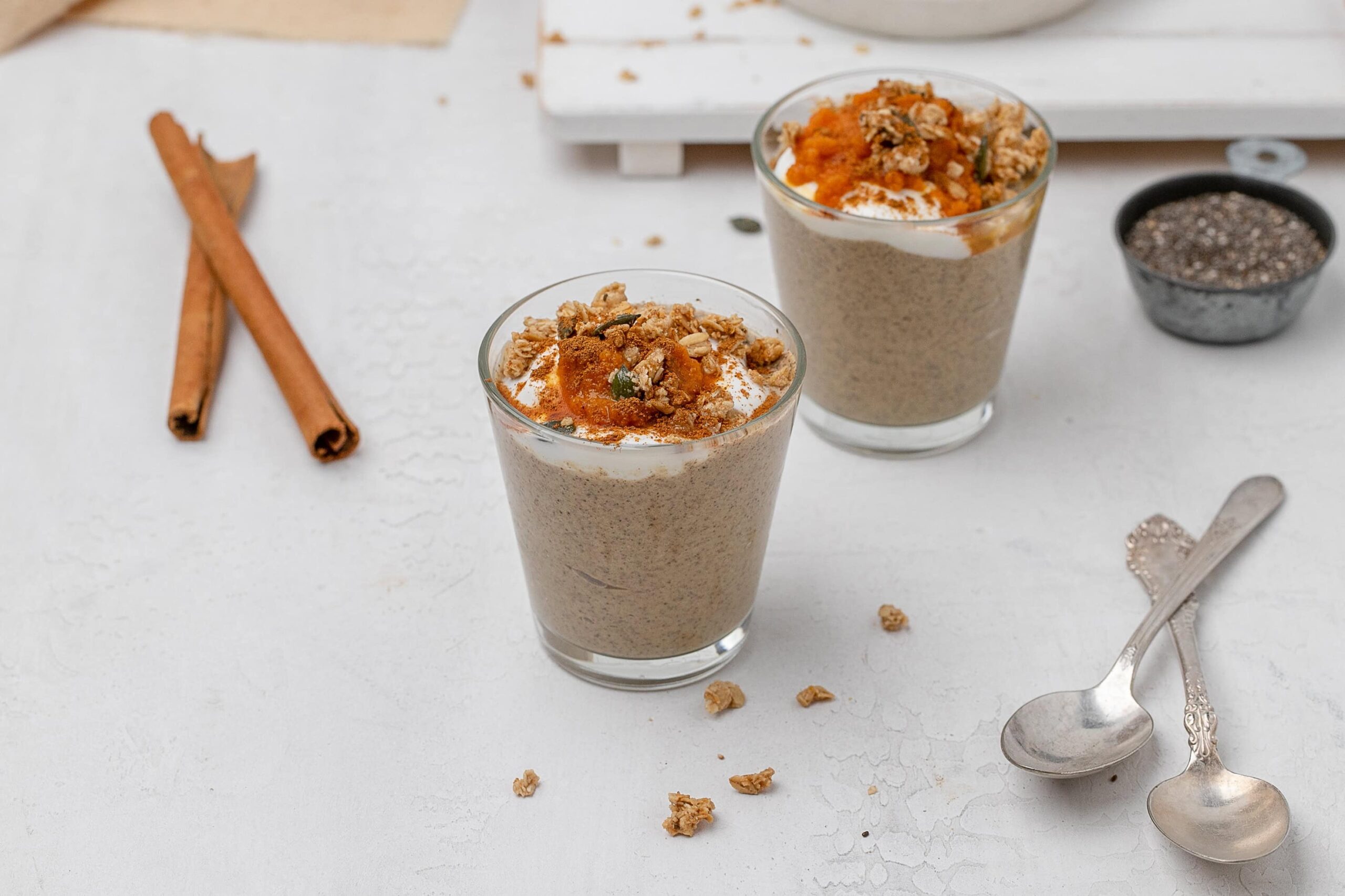 pumpkin chia seed pudding in a glass jar with toppings.
