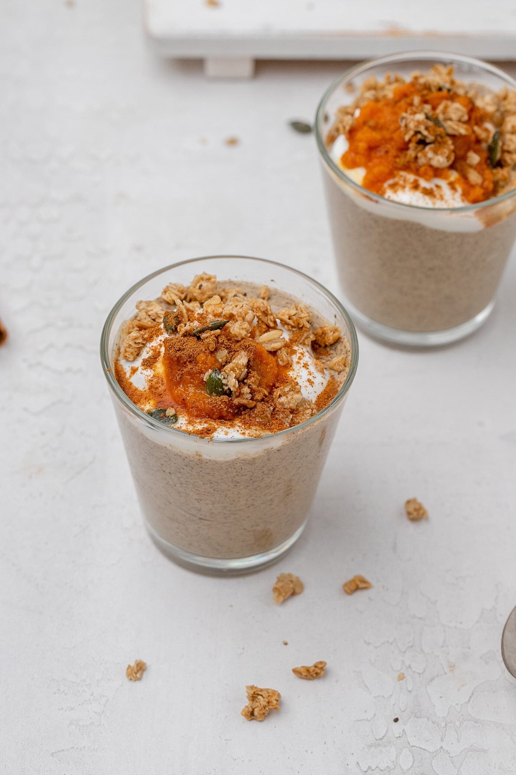 pumpkin chia seed pudding in a glass jar with toppings. 
