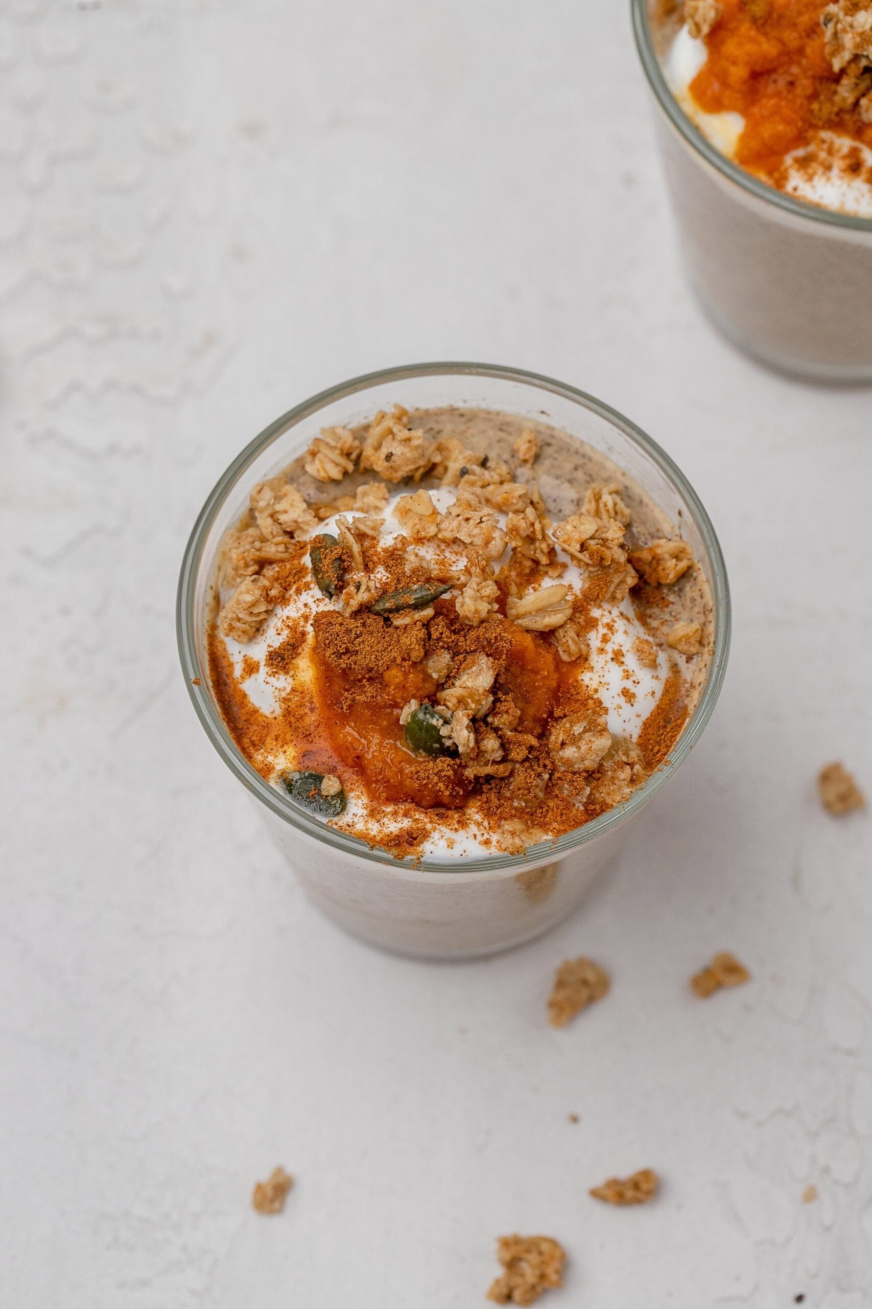 pumpkin chia seed pudding in a glass jar with toppings. 