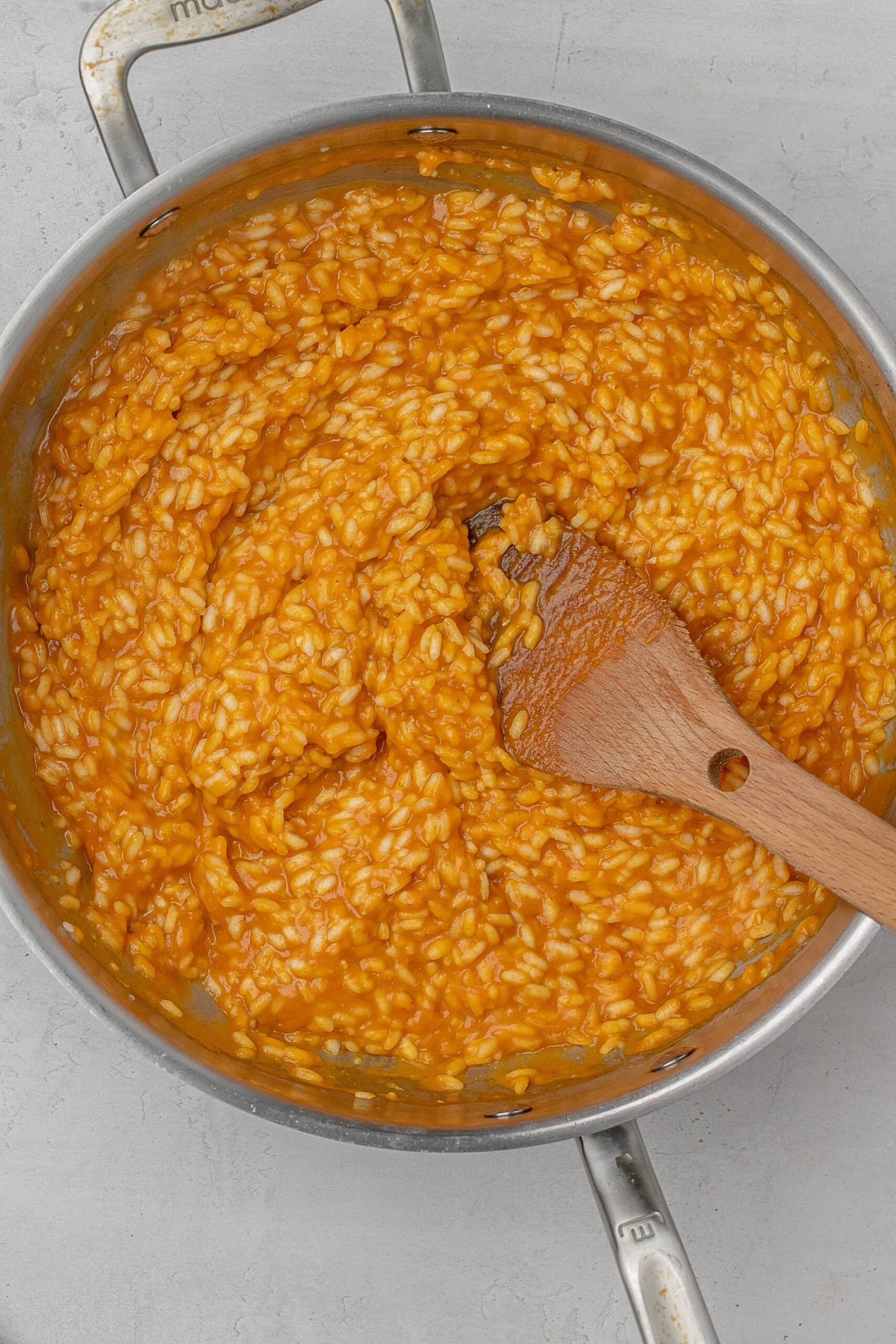 creamy pumpkin risotto in pot.